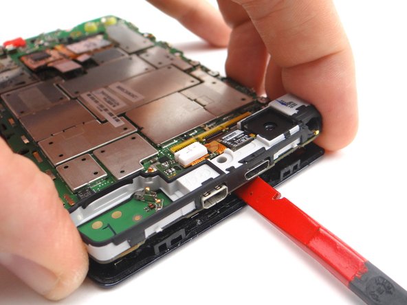 Picture 3: Then twist counter-clockwise to free the top of the logic board enough to grab it with your fingers.