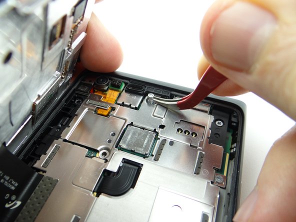 Picture 2: Remove two 3.3 mm #00 Phillips screws.  Place in SLOT 3.