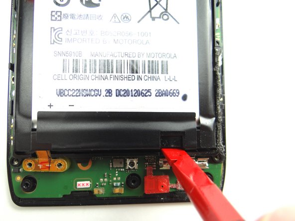 Pictures 2 &amp; 3: Wedge spudger underneath the notch in the battery in the lower-right corner and pry up.