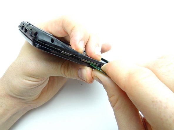 Pictures 2 &amp; 3: Separate the mid-frame under the volume rocker with a guitar pick.