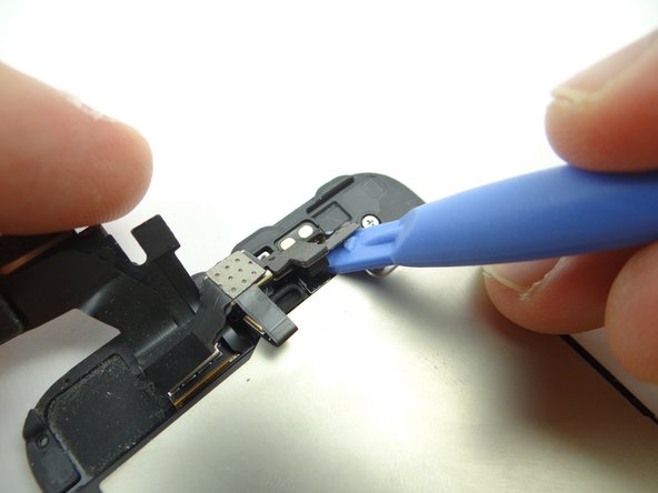 Picture 2: Pry the cable free up from the bottom, as pictured.