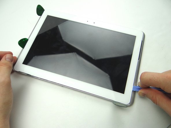 Picture 1: Insert the blue pry tool in the lower-right corner.