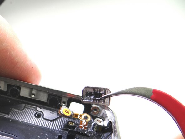 Picture 1: Remove the mute switch with curved-tip tweezers.