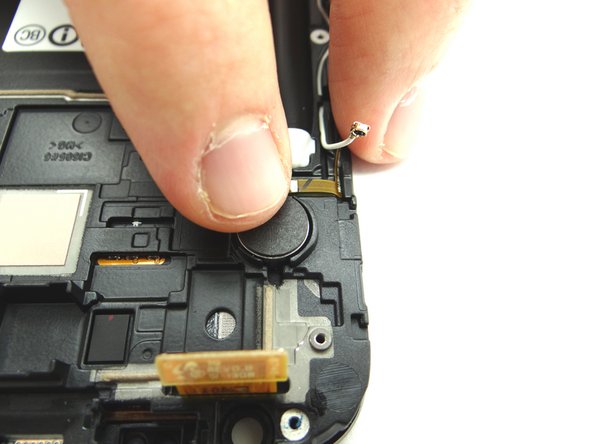 Use your finger to secure the ribbon cable to the phone and work your way back toward the vibrator.