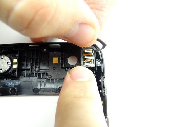 Seat the headphone jack while holding the adhesive frame out of the way.