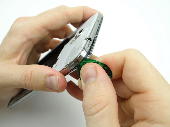 Pictures 1 &amp; 2: Start working your way down the volume rocker side.  Remove the guitar pick when you reach the volume rocker.