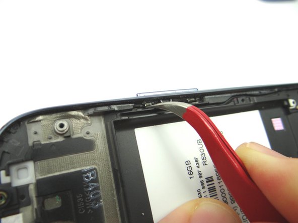 Use the Curved Tip Tweezers to remove the volume button by pushing it out of the frame. Place volume button into COMPARTMENT F.