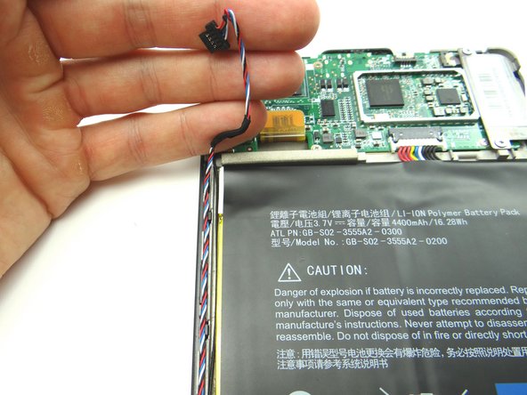 Picture 1: Thread speaker cable through the track just left of the battery.