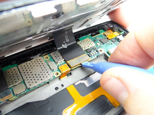 Close the device to a roughly 70° angle so there's no tension on the LCD cable as you use a blue pry tool to disconnect it.