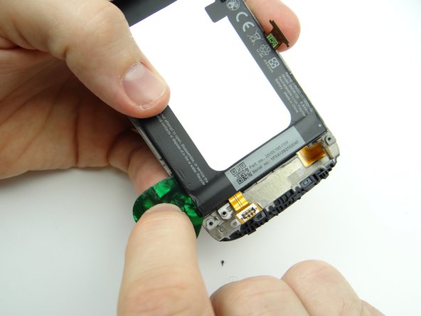 Strong adhesive runs the length of the battery on either side, holding it to the front panel.  Additionally, there's a circuit board at the bottom of the battery. Take extra care to avoid bending the circuit board: