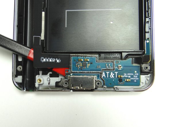 Sweep down and to the right to loosen the adhesive holding it in place.