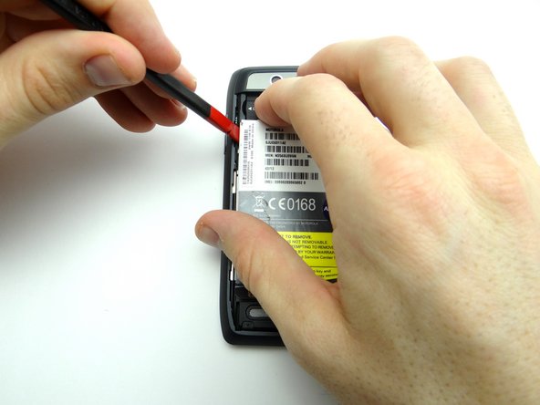 Apply low-level heat (100° Celsius or less) to the left side of the battery for 30 seconds or less to loosen the adhesive.