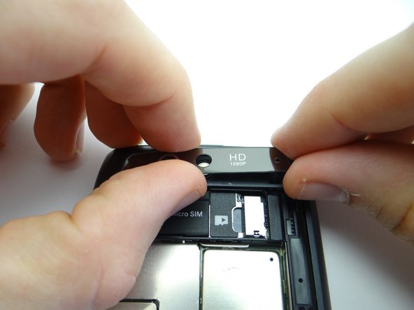 Pinch the trim with your fingers and continue peeling it away.