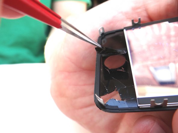 Picture 2: Pull the home button up just enough that you can fit your index finger into the opening.