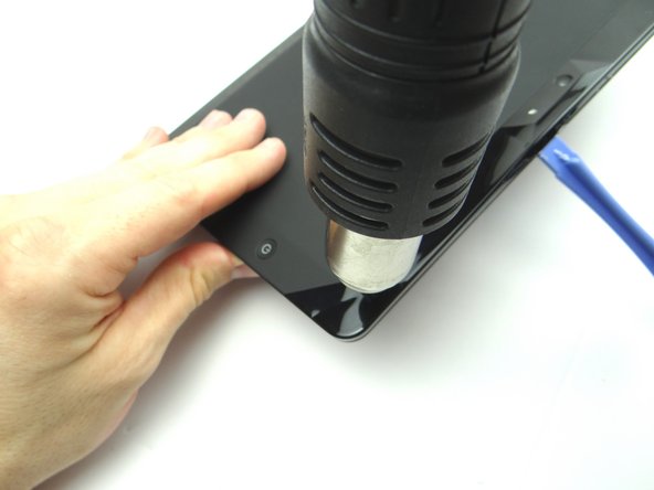 Apply low level heat (100° Celcius) from the center to the power button.