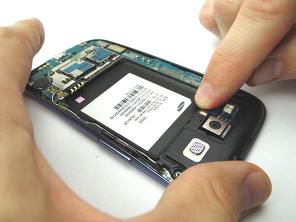 Picture 2: Use your finger to reattach the headphone jack/speaker assembly cable.