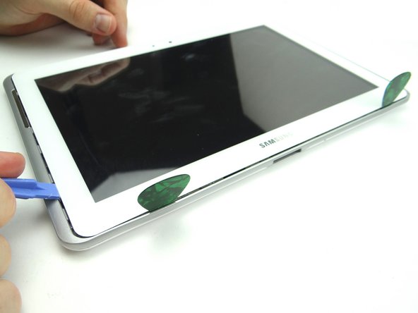 Picture 1: Insert the blue pry tool in the lower-left corner.