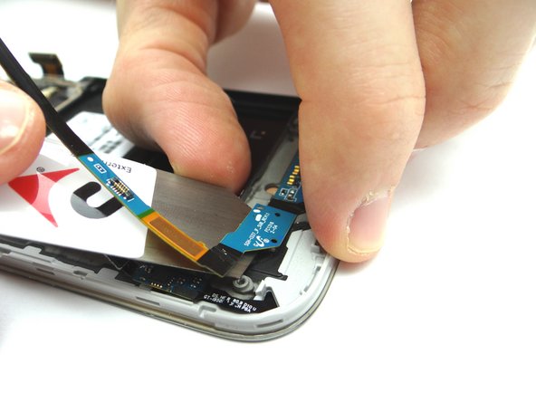 Use the iSesamo to gently pry the charging port board away from the phone. Place into COMPARTMENT C.