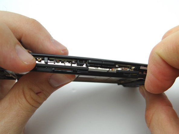 Use your fingers to continue peeling the remaining clips holding the mid-frame to the display.