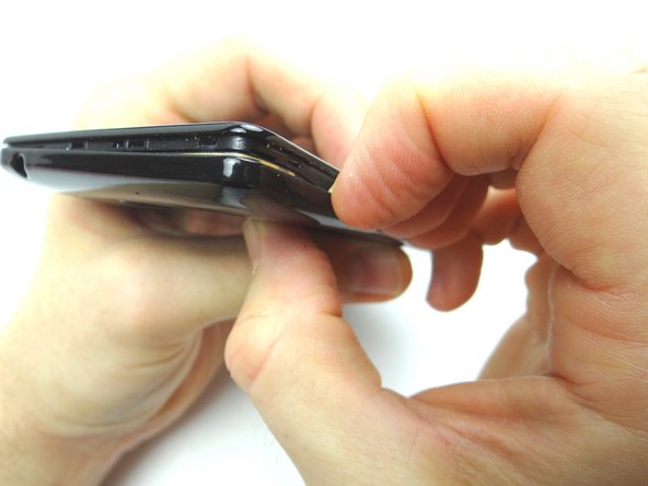 Pictures 2 &amp; 3: Peel up the battery cover as much as you can without creating stretch marks.