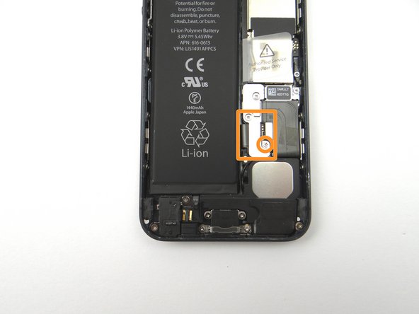 Picture 2: From SLOT 5, reseat the shield that goes over the top of the battery connector. Replace the 1.6 mm Phillips screw, also in SLOT 5, that goes into the bottom of the shield.