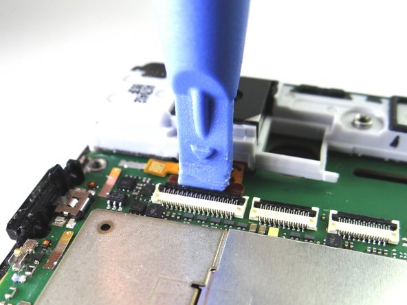 Picture 1: Place blue pry tool under black swing bar of ZIF connector and lift up to open it.