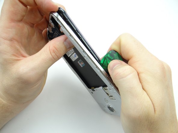 Picture 1: Move up the side of the mid-frame.  Remove the guitar pick before you reach the power button.