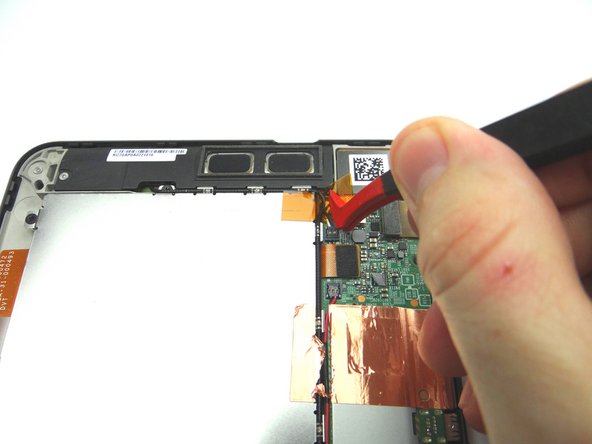 Use plastic tweezers to remove the Kapton tape covering the top speaker connector.
