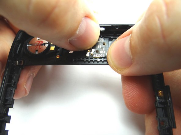 Picture 3: Push the camera flash into place on the three pegs.