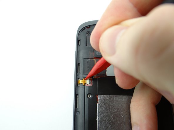 Pictures 1 &amp; 2: Use the pointed tip of the spudger to push the cable away from the socket slightly.  Use your finger to finish pulling the cable free.