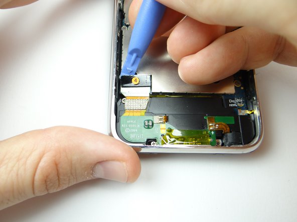 Picture 1: Use the blue pry tool to pull up foam piece covering cable 4 connector.