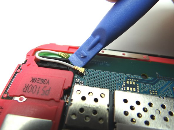 Picture 1: Use blue pry tool to disconnect antenna from logic board.  Leave antenna connected to the loudspeaker.