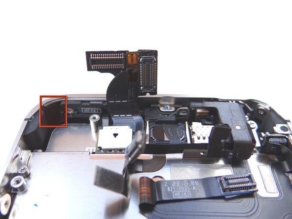 Pictures 1 and 2: There may be a piece of electrical tape covering the display mounting tab in the upper-left hand corner of the phone.  If so, remove and discard it.