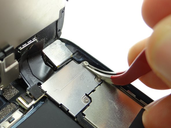 Picture 3: Use curved-tip tweezers to seat the non-magnetic 1.6 mm #00 Phillips screw from SLOT 2.  Tighten the screw.