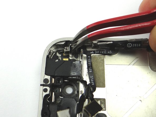 Picture 3: Use Curved Tip Tweezers to move the mute switch into position.