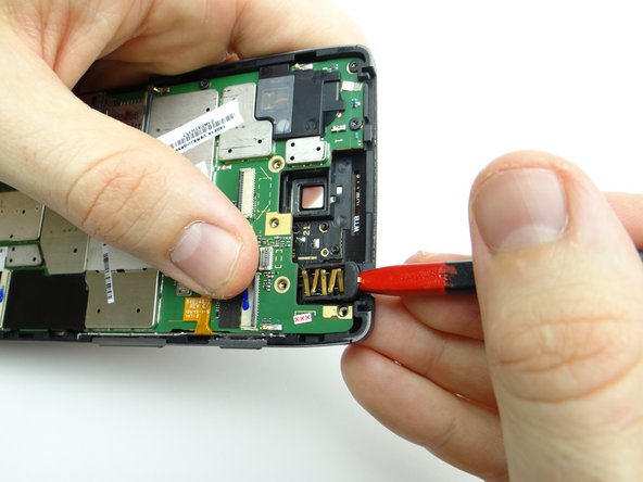 Use the pointed tip of the spudger to pry the headphone jack free.