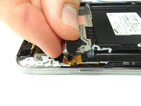 The vibrator and power button cable are one assembly as shown in Picture 2: