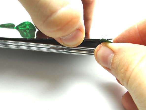 Picture 1: Continue prying up the top edge about an inch, until you see the LCD cable cable in the upper-right corner.