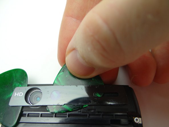 Picture 1: Use a guitar pick to peel up the right side. If you encounter resistance, apply more heat.