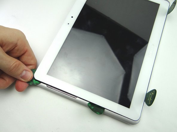 Picture 2: Put a guitar pick in place of the spudger to hold the upper-left corner open.