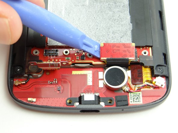 Use blue pry tool to disconnect charging port daughter board cable.