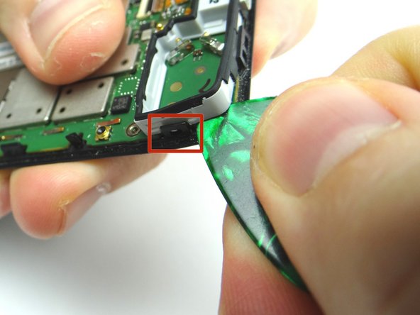 Picture 1: Use guitar pick to free the marked clip.