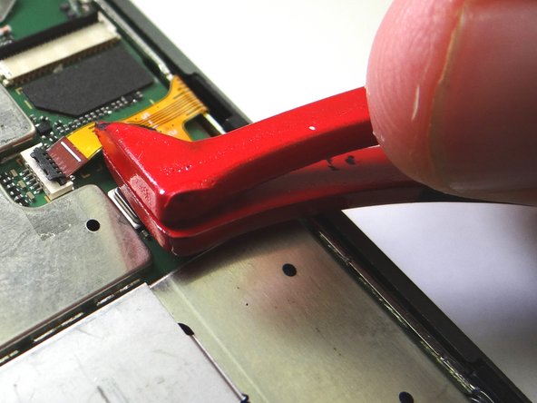 Picture 1: Use plastic tweezers to seat volume &amp; power buttons cable.