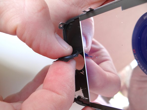 Picture 3: Use your index finger and thumb to carefully remove the home button from the broken display.