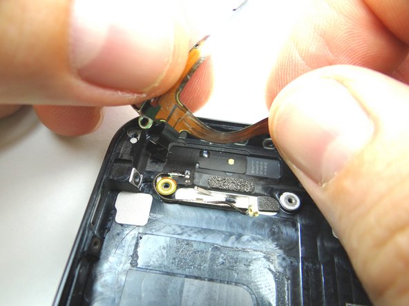 Picture 2: Place the contacts on the ribbon cable back into position in the top left portion of the rear case.