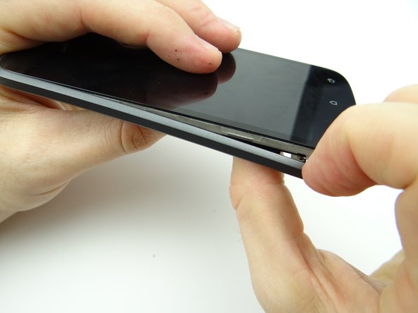 Picture 3: Use your fingers to continue separating the mid-body from the front panel, starting in the lower-left corner.