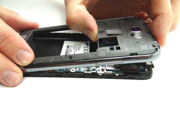 Once all clips connecting the mid-frame to the front assembly are freed, use your fingers to gently lift the mid-frame away from the phone.