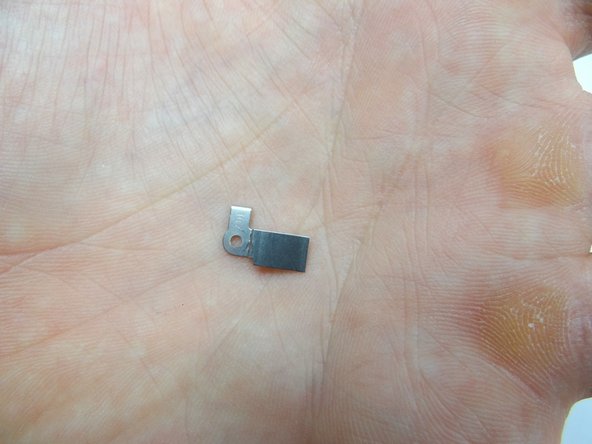 Pictures 2 &amp; 3: Seat the bracket from SLOT 5.  Replace 1.8 mm #00 Phillips screw from SLOT 5 to hold down bracket.