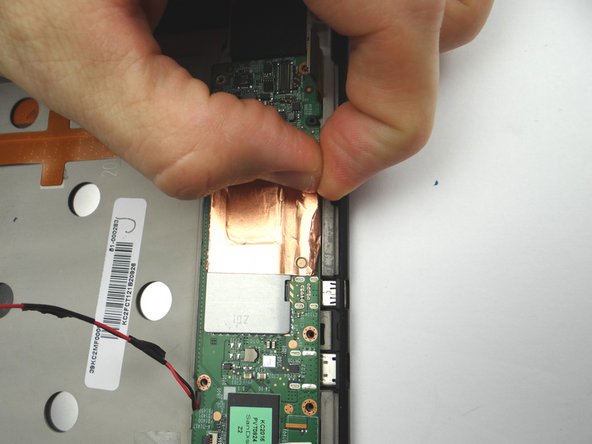 Picture 3: Continue peeling the tape up from the mid-plate with your fingers.