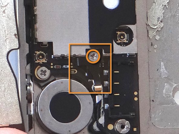 Use your fingers or fine point tweezers to replace the L-Shaped Antenna Shield found in SLOT 9.
